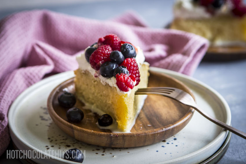 tres leches cake with whipped cream and fruit